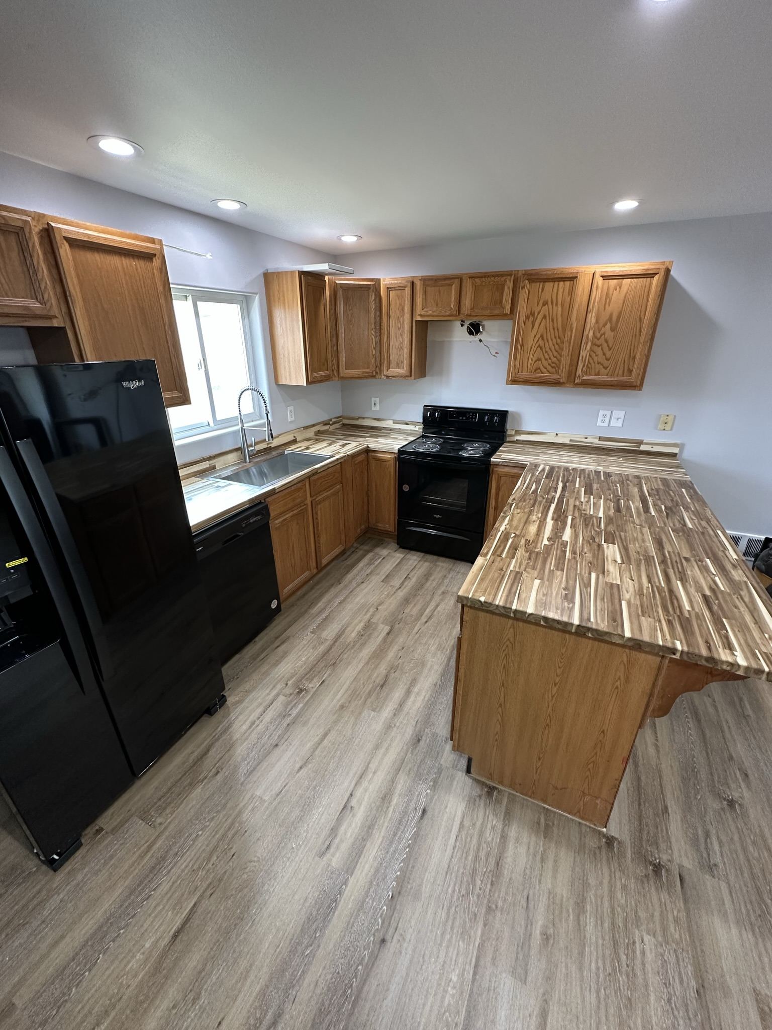 Remodeled kitchen with wood cabinetry and island in Whitefish, MT